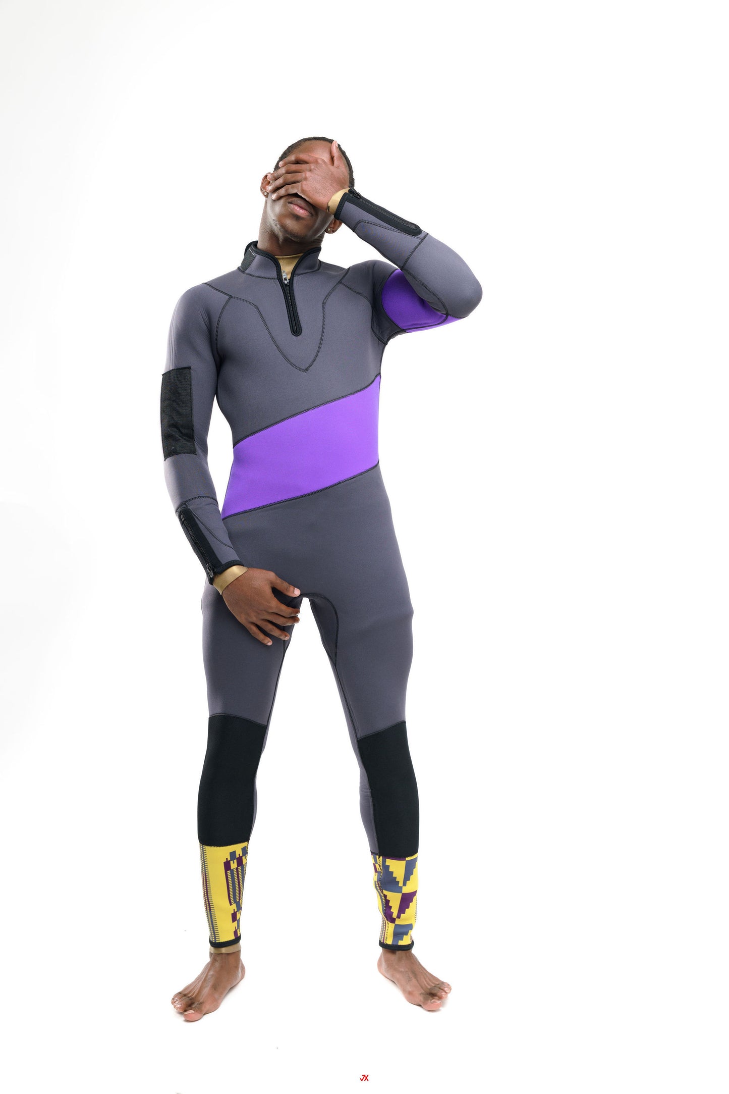 Person wearing a gray and purple wetsuit with kente accents on a white background