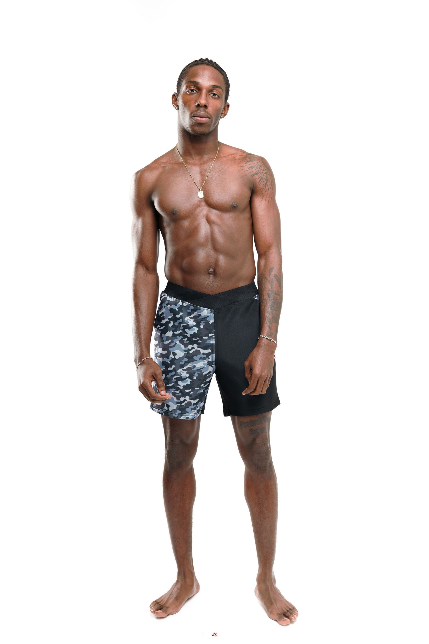 Man wearing black and grey camouflage 6" swim shorts on a white background