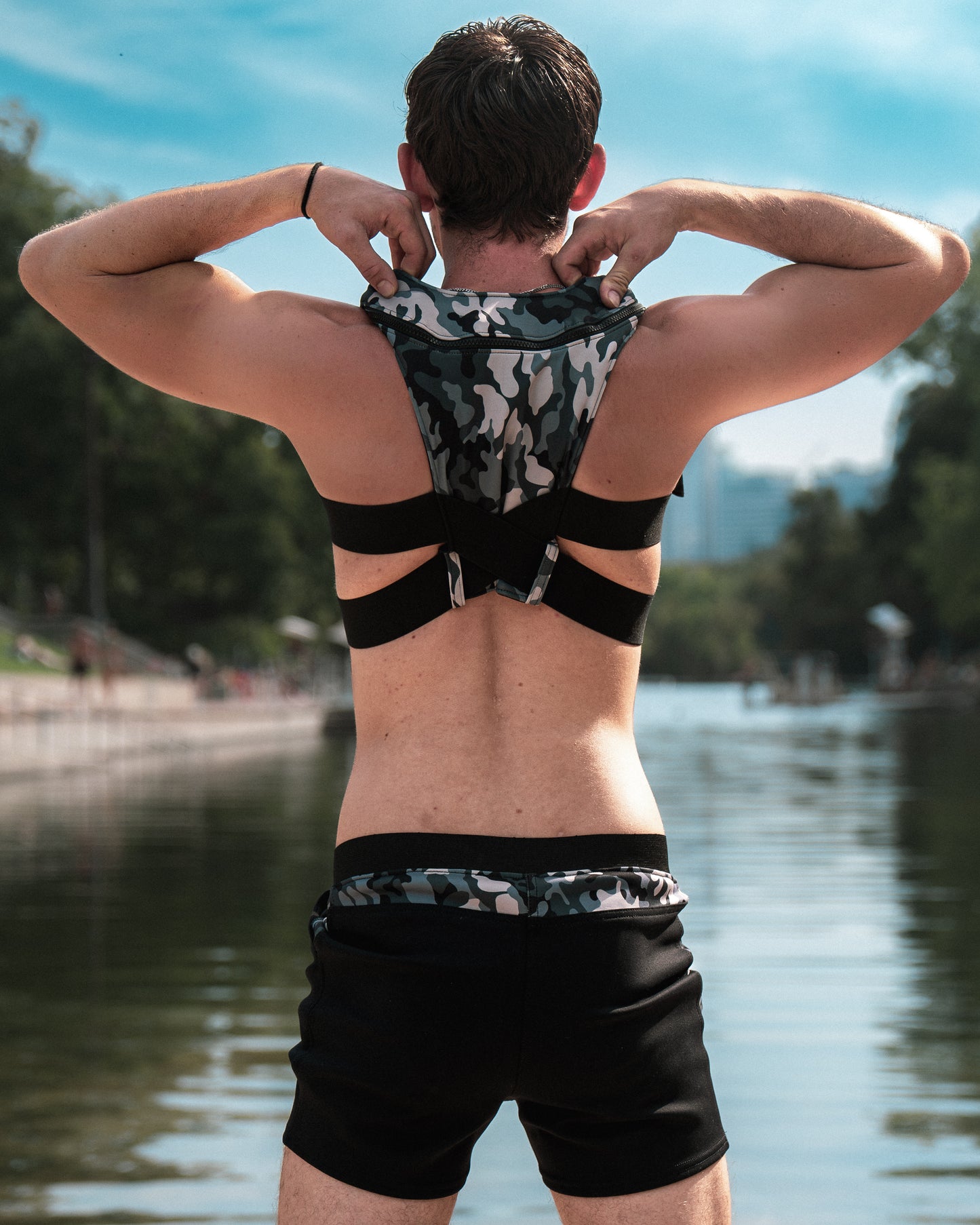 Man adjusting the Perfect 10 life jacket by G180 Swim, fashionable, functional, sleek, fun to wear
